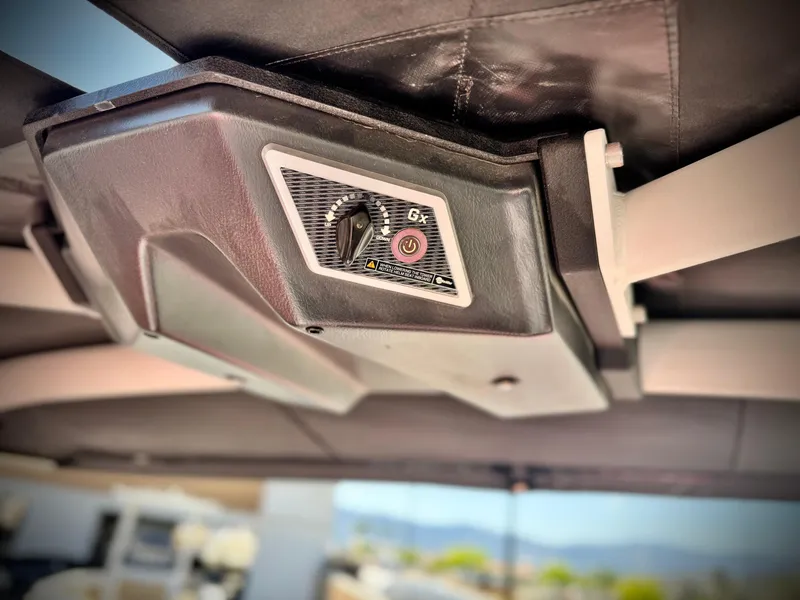 Slide: The Image of 2021 Malibu Wakesetter 25 LSV boat control panel under canopy. - 37