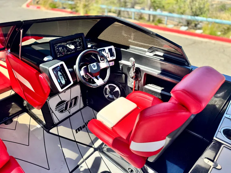 Slide: The Image of 2021 Malibu Wakesetter 25 LSV cockpit with red seats and modern dashboard. - 38
