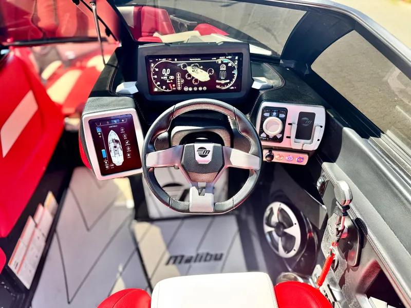 Slide: The Image of 2021 Malibu Wakesetter 25 LSV dashboard with modern controls and red seating. - 39
