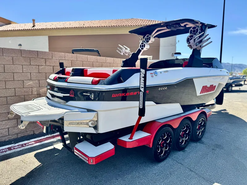 Slide: The Image of 2021 Malibu Wakesetter 25 LSV boat on trailer, featuring sleek design and vibrant colors. - 5