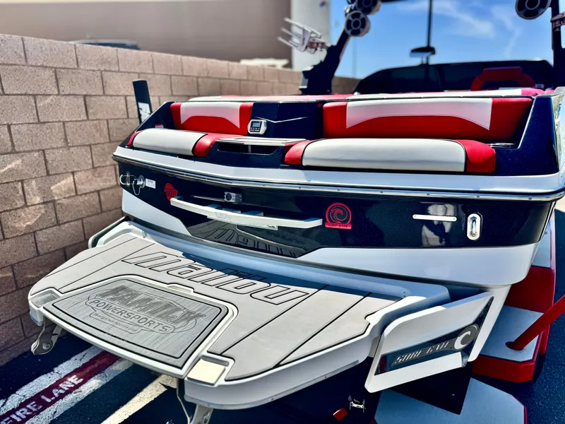 Slide: The Image of 2021 Malibu Wakesetter 25 LSV boat with red and white seating, rear view. - 6