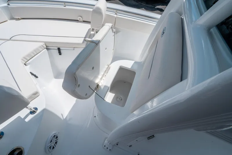 Slide: The Image of 2025 Sea Hunt Ultra 229 boat interior with open storage compartment. - 27