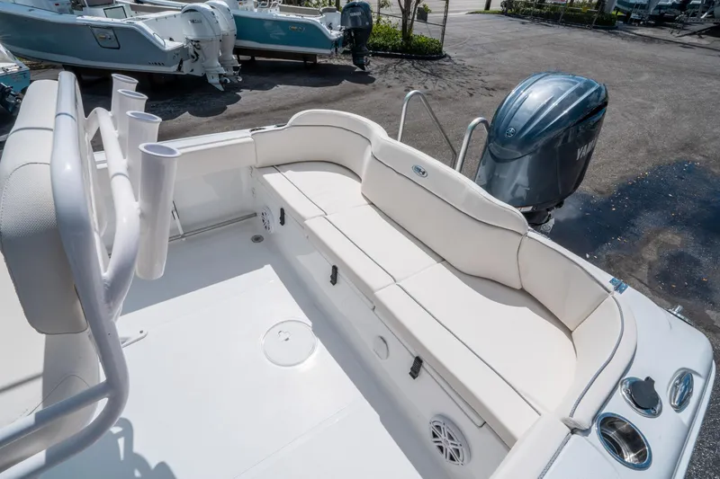 Slide: The Image of 2025 Sea Hunt Ultra 229 boat interior with seating and Yamaha outboard motor. - 12