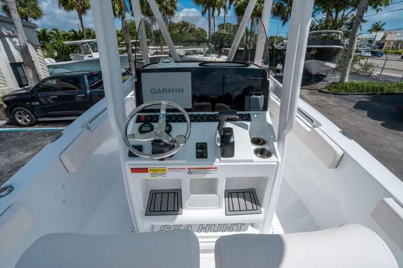Slide: The Image of 2025 Sea Hunt Ultra 229 boat dashboard with Garmin navigation system and steering wheel. - 15