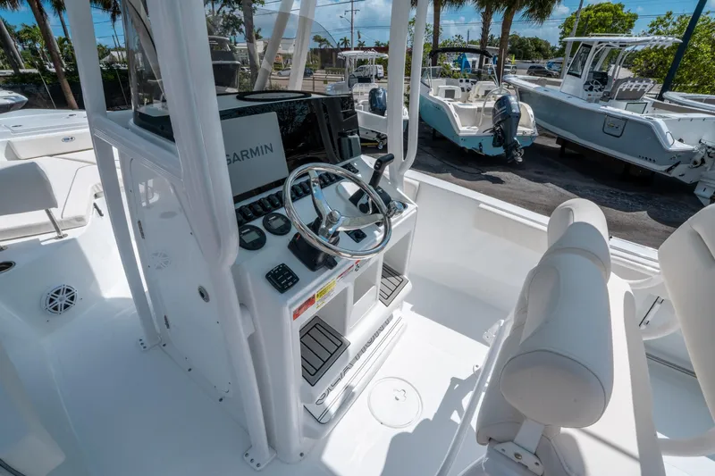 Slide: The Image of 2025 Sea Hunt Ultra 229 boat cockpit with Garmin navigation system and steering wheel. - 16