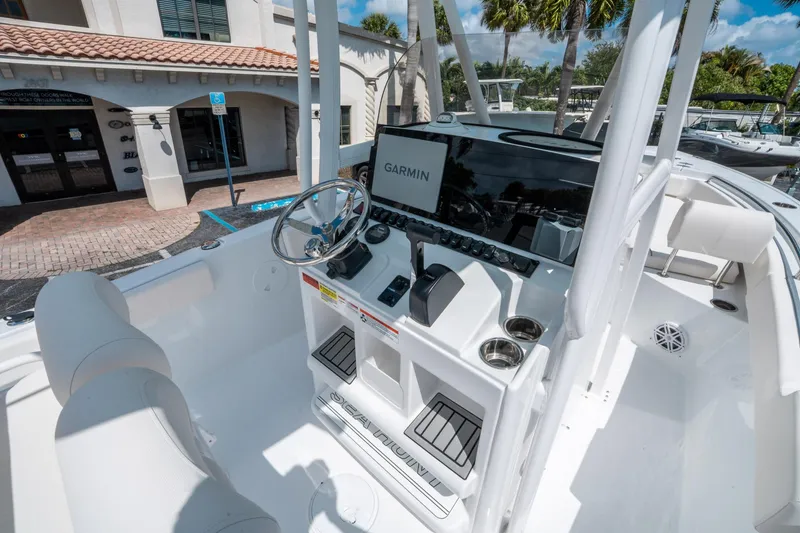Slide: The Image of 2025 Sea Hunt Ultra 229 boat cockpit with Garmin navigation system, sleek design, and modern controls. - 17