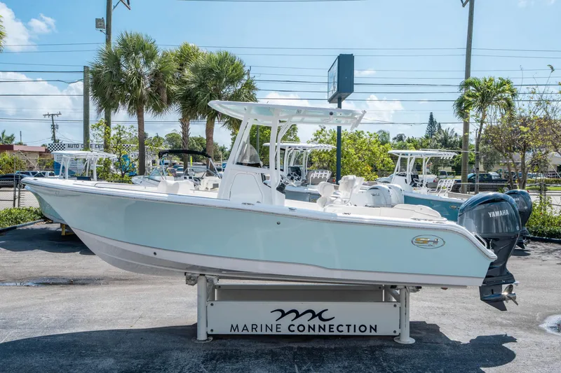 Slide: The Image of 2025 Sea Hunt Ultra 229 boat displayed at Marine Connection dealership. - 5