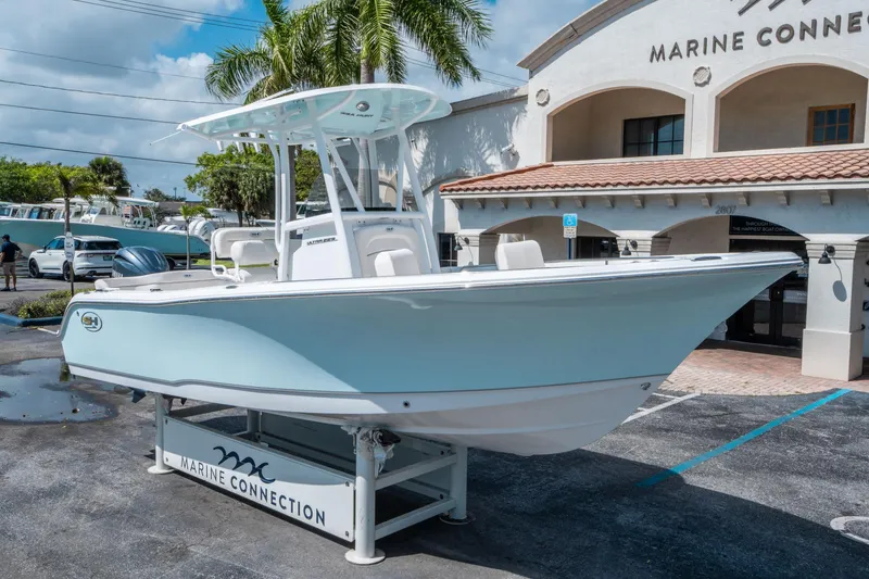 Slide: The Image of 2025 Sea Hunt Ultra 229 boat displayed at Marine Connection dealership. - 8