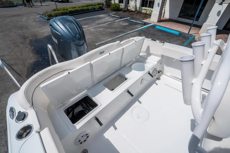 Slide: The Image of 2025 Sea Hunt Ultra 229 boat interior with storage compartments and Yamaha engine. - 14