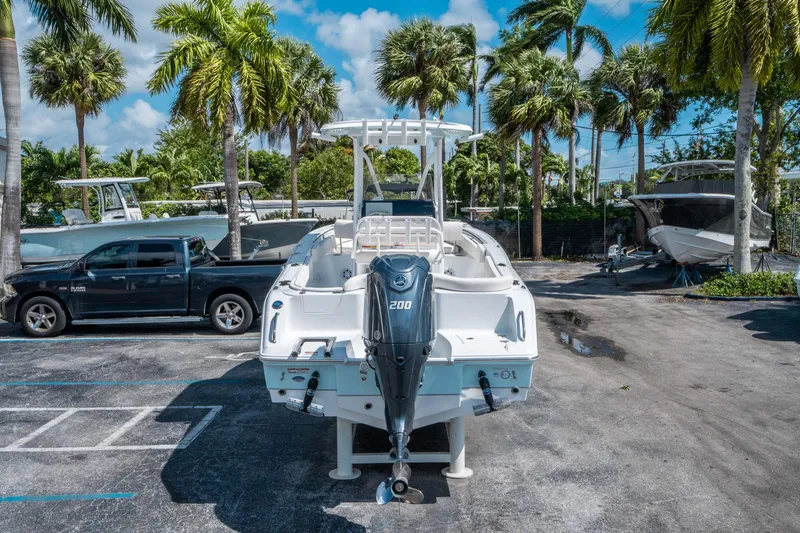 Slide: The Image of 2025 Sea Hunt Ultra 229 boat with outboard motor in a tropical setting. - 3