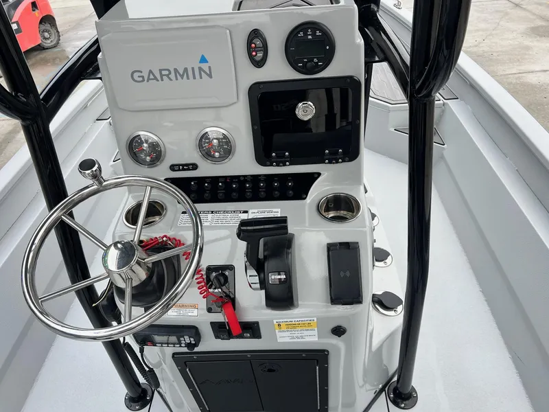 Slide: The Image of 2023 Avid 23 Mag boat console with Garmin navigation and steering wheel. - 14