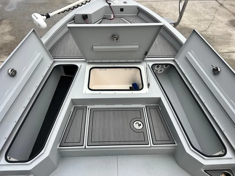 Slide: The Image of 2023 Avid 23 Mag boat with open storage compartments and sleek design. - 15