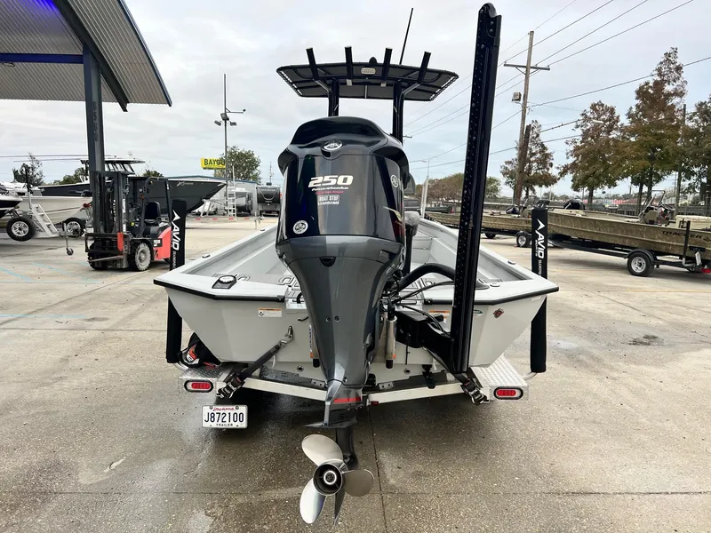 Slide: The Image of 2023 Avid 23 Mag boat with powerful 250 engine, displayed at a dealership. - 3