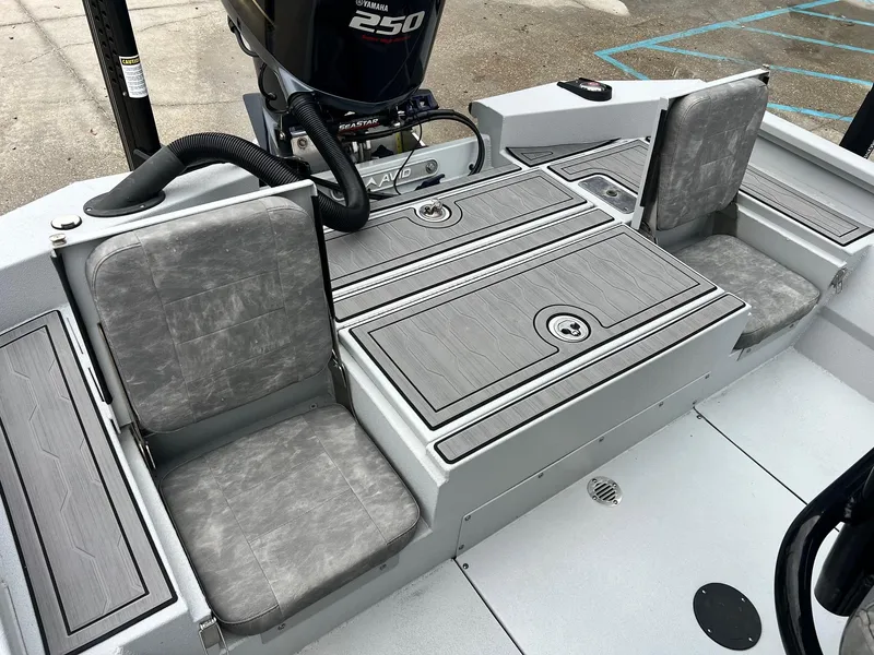 Slide: The Image of 2023 Avid 23 Mag boat interior with gray seating and Yamaha 250 engine. - 4