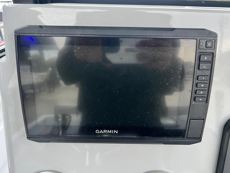 Slide: The Image of Garmin display on 2023 Avid 23 Mag boat dashboard, featuring control buttons. - 6