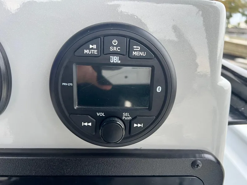 Slide: The Image of JBL PRV-275 marine stereo on Avid 23 Mag boat, featuring Bluetooth and control buttons. - 7