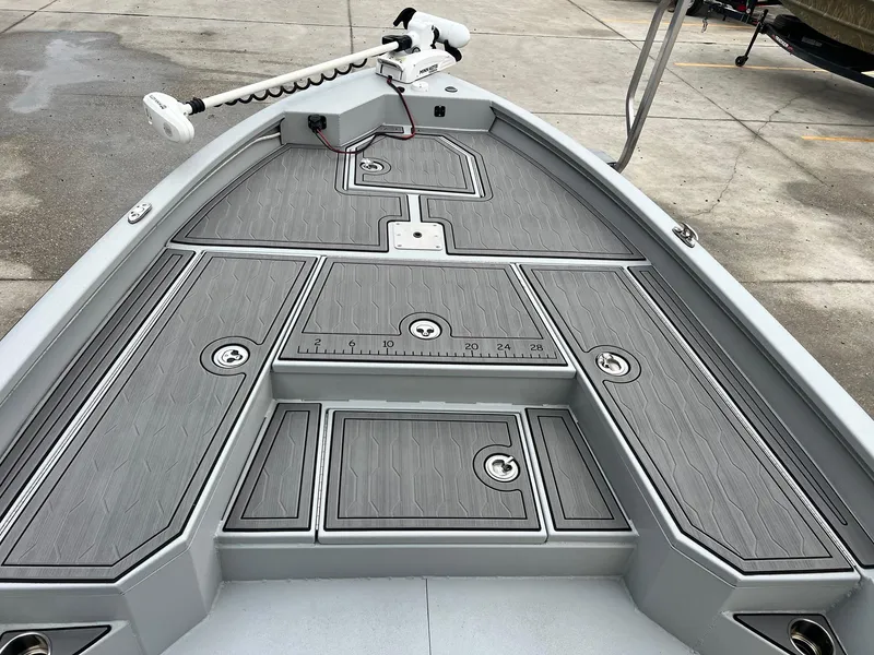 Slide: The Image of 2023 Avid 23 Mag boat deck with gray non-slip surface and mounted trolling motor. - 8