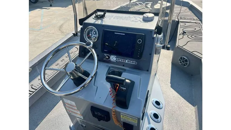 Slide: The Image of 2023 Express H22B boat console with steering wheel, controls, and navigation display. - 6