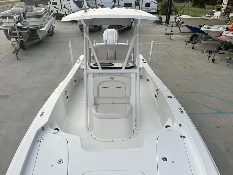 Slide: The Image of 2022 Sea Hunt BX 25 BR boat with T-top, parked in a marina. - 15