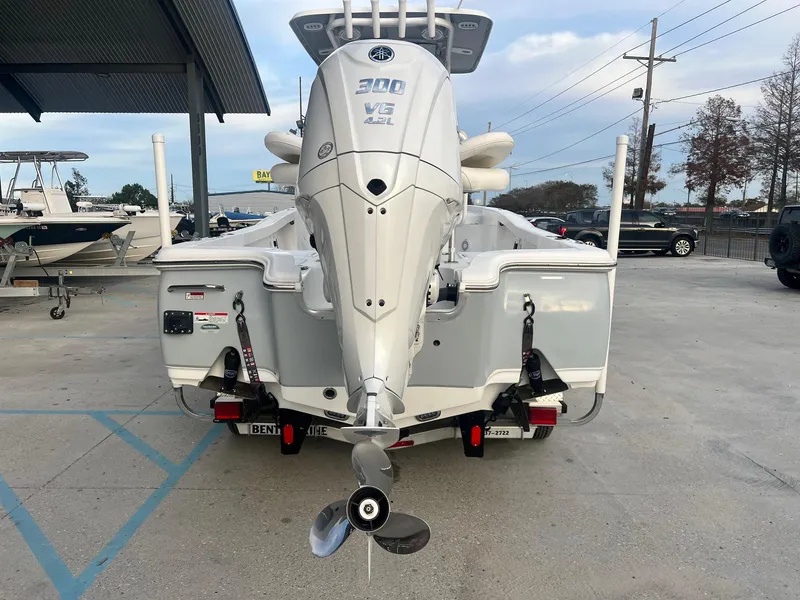 Slide: The Image of 2022 Sea Hunt BX 25 BR boat with powerful outboard motor in a marina setting. - 5