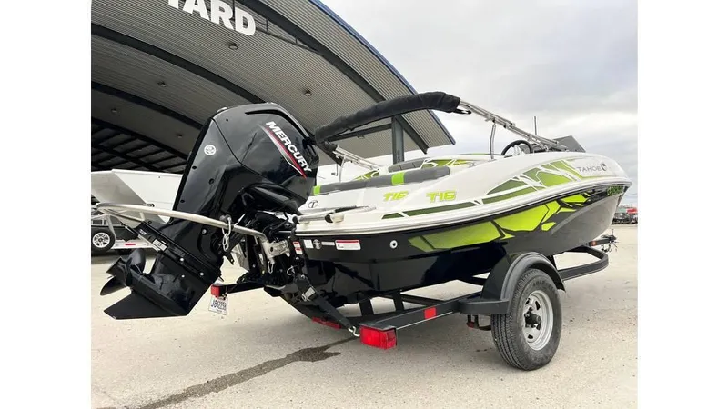 Slide: The Image of 2022 Tahoe T16 boat with Mercury engine on trailer, parked outdoors. - 3