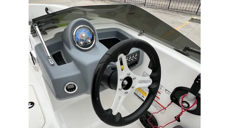 Slide: The Image of 2022 Tahoe T16 boat dashboard with steering wheel and control panel. - 8
