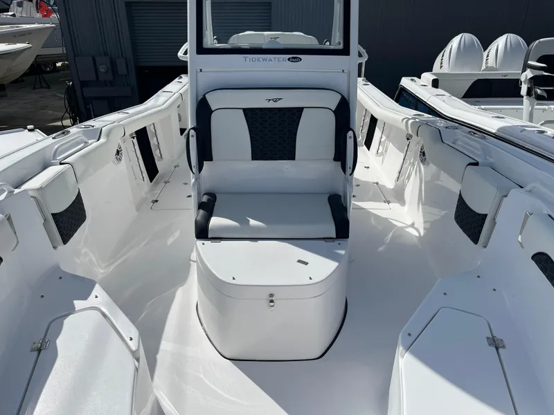 Slide: The Image of 2024 Tidewater 256 CC Adventure boat interior with seating and storage. - 11