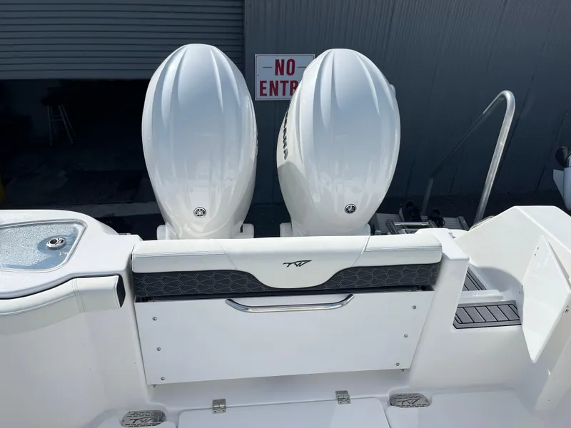 Slide: The Image of 2024 Tidewater 256 CC Adventure boat with dual engines, rear view. - 14