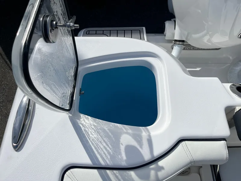 Slide: The Image of 2024 Tidewater 256 CC Adventure boat with open storage compartment. - 16