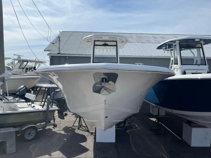 Slide: The Image of 2024 Tidewater 256 CC Adventure boat displayed outdoors, front view. - 17