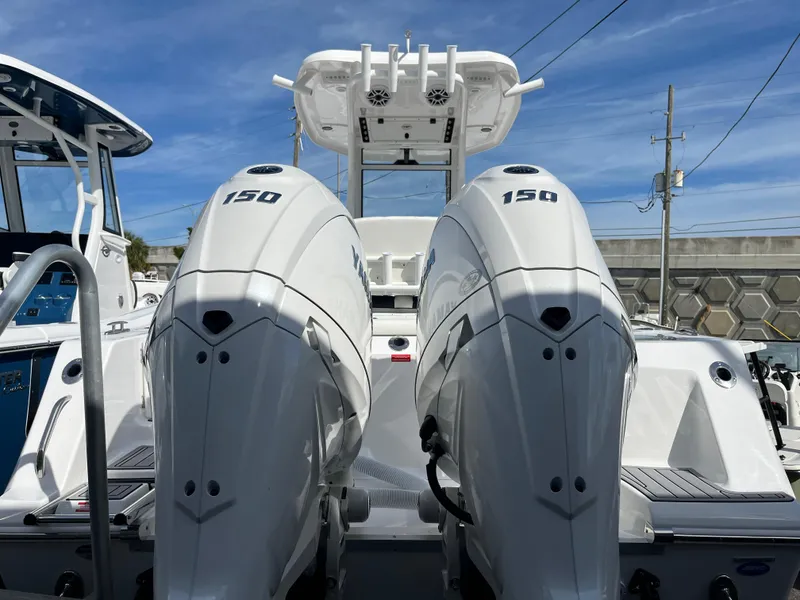 Slide: The Image of 2024 Tidewater 256 CC Adventure boat with dual 150 horsepower engines, rear view. - 4