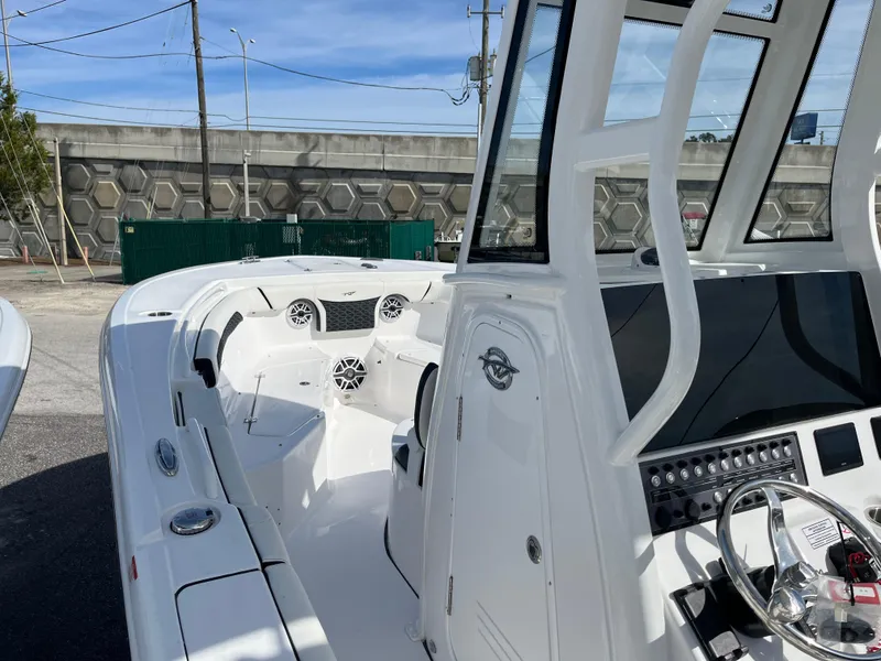 Slide: The Image of 2024 Tidewater 256 CC Adventure boat, featuring a sleek white interior and modern dashboard controls. - 8
