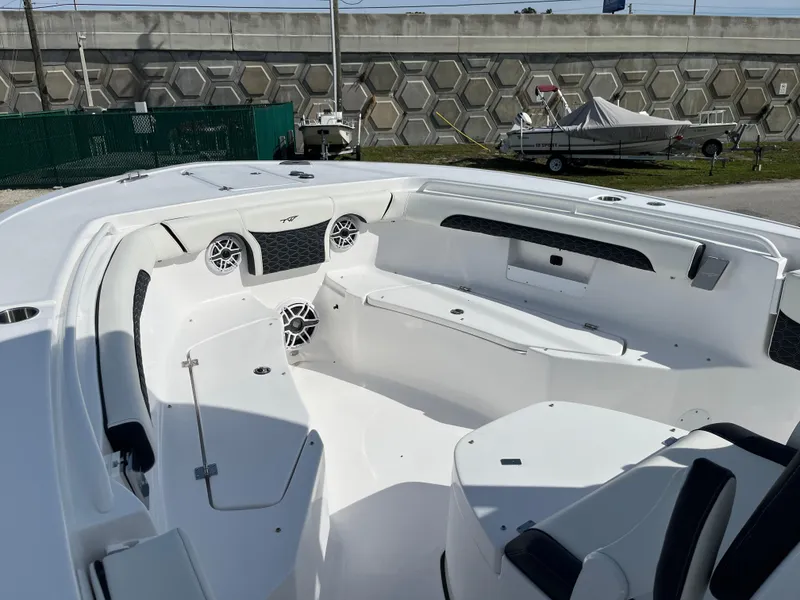 Slide: The Image of 2024 Tidewater 256 CC Adventure boat interior with seating and speakers. - 9