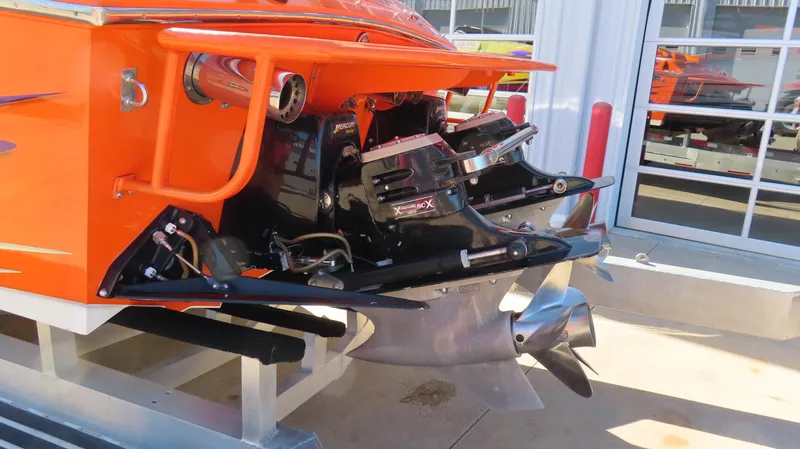 Slide: The Image of 2003 Cigarette 38 Top Gun boat, orange exterior, detailed view of engine and propeller. - 11