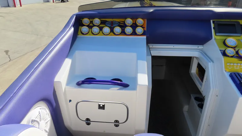 Slide: The Image of 2003 Cigarette 38 Top Gun boat dashboard with gauges and purple accents. - 12