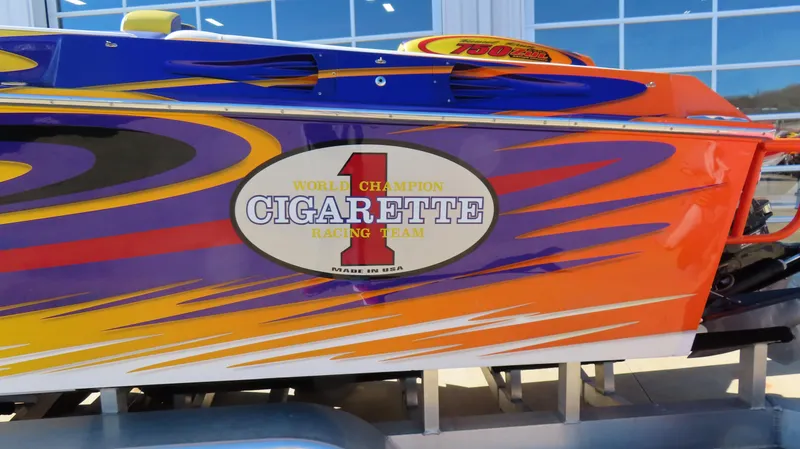 Slide: The Image of 2003 Cigarette 38 Top Gun boat with vibrant racing graphics and logo. - 17