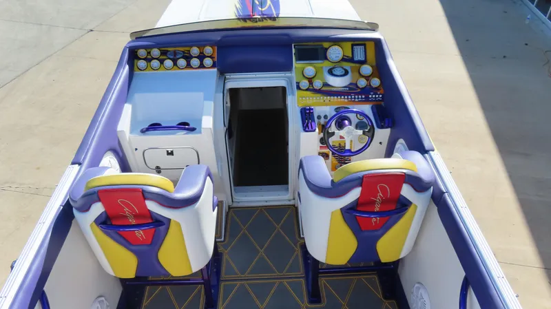 Slide: The Image of 2003 Cigarette 38 Top Gun boat cockpit with vibrant seats and detailed dashboard. - 20