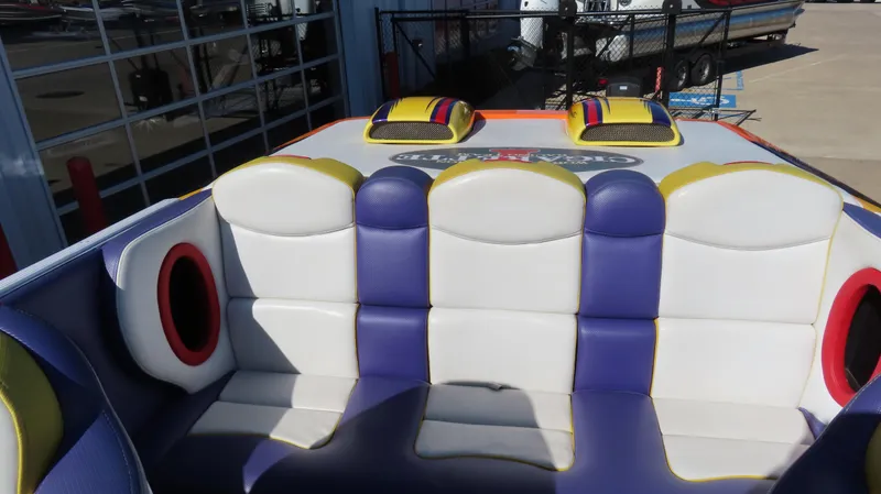 Slide: The Image of 2003 Cigarette 38 Top Gun boat interior with colorful seating and speaker system. - 21