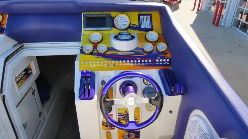 Slide: The Image of 2003 Cigarette 38 Top Gun boat dashboard with vibrant gauges and controls. - 22