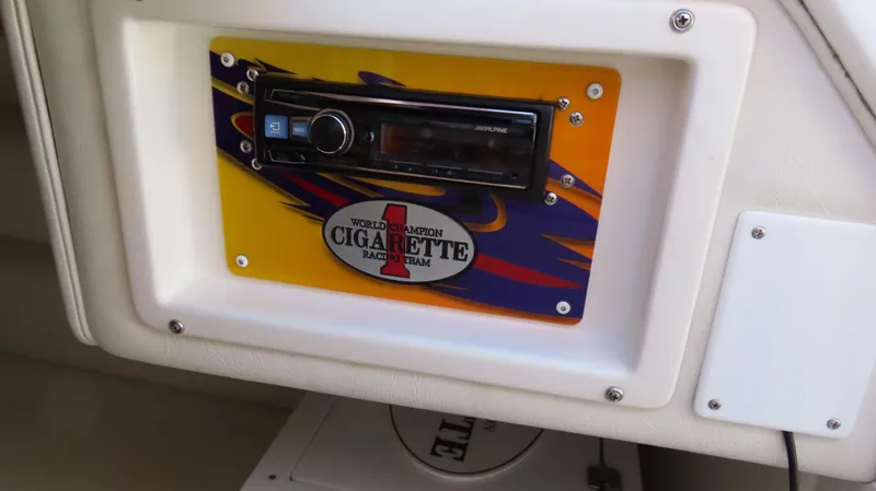 Slide: The Image of 2003 Cigarette 38 Top Gun dashboard with stereo system and vibrant design. - 25