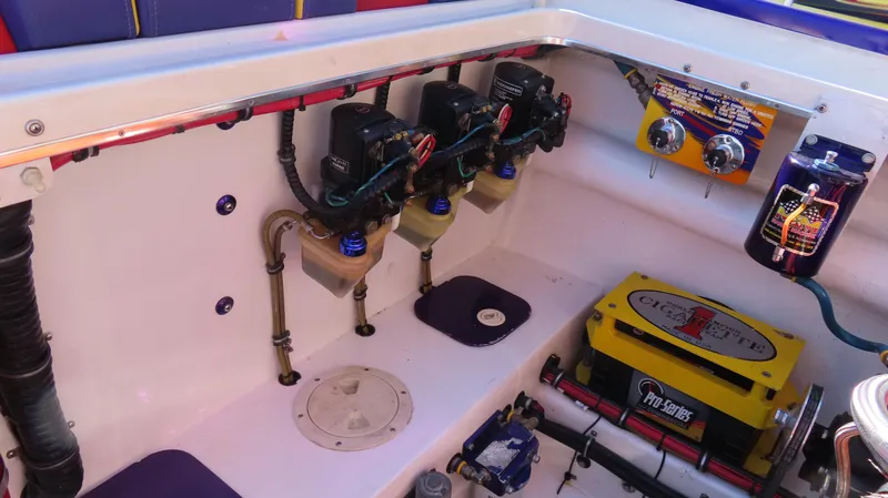 Slide: The Image of Engine compartment of a 2003 Cigarette 38 Top Gun boat, showcasing mechanical components. - 29