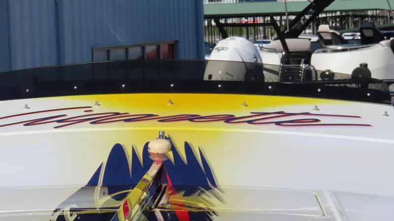 Slide: The Image of 2003 Cigarette 38 Top Gun boat with vibrant graphics and logo. - 30