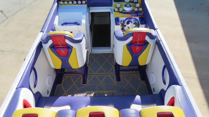 Slide: The Image of 2003 Cigarette 38 Top Gun boat interior with vibrant seating and detailed dashboard. - 4