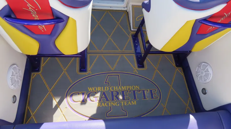 Slide: The Image of 2003 Cigarette 38 Top Gun boat interior with colorful seats and branded flooring. - 5