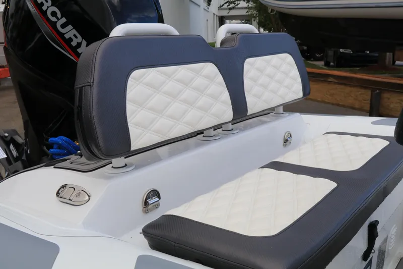 Slide: The Image of 2023 Highfield SP390 boat seats with quilted upholstery and Mercury engine in background. - 16