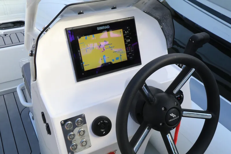 Slide: The Image of 2023 Highfield SP390 boat dashboard with Simrad navigation system and steering wheel. - 22