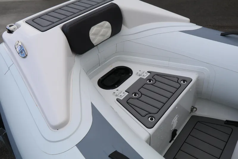 Slide: The Image of 2023 Highfield SP390 boat interior with cushioned seating and storage compartments. - 24