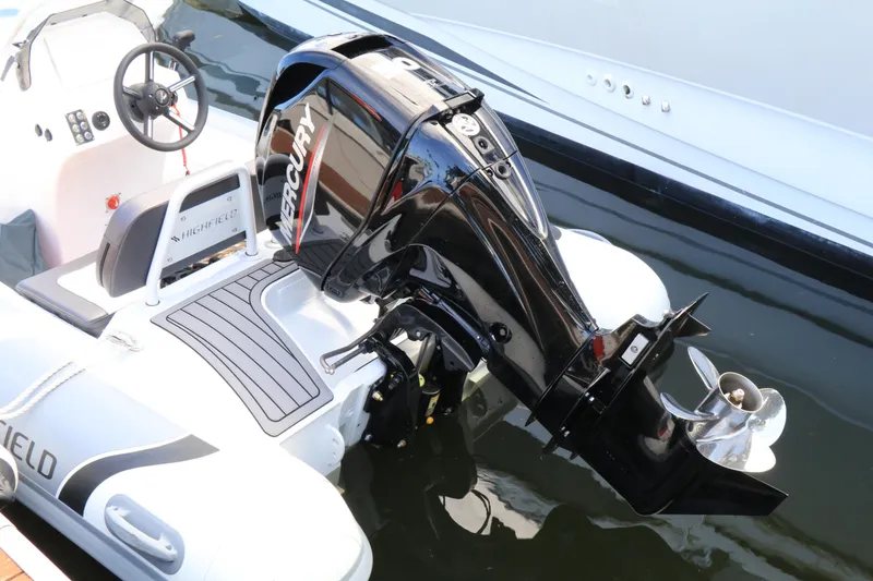 Slide: The Image of 2023 Highfield SP390 boat with Mercury outboard motor, docked on calm water. - 7