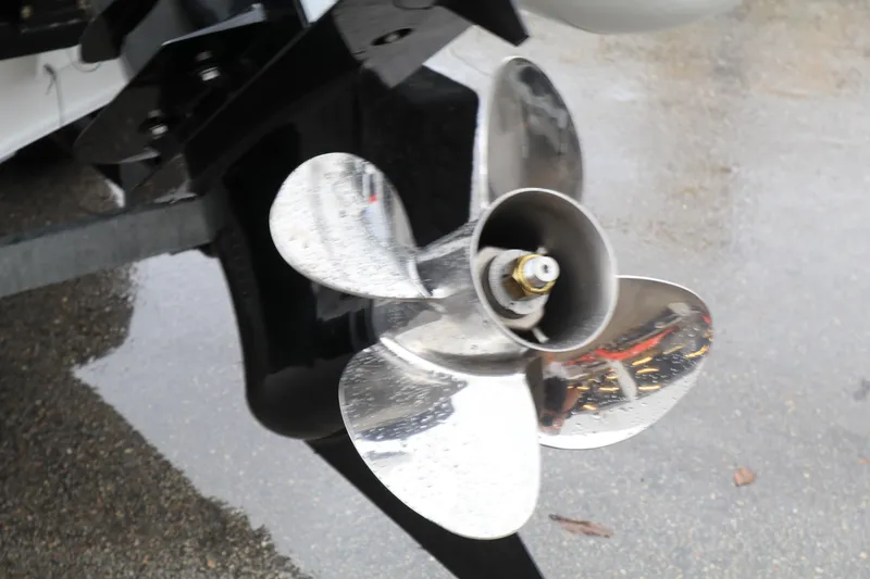 Slide: The Image of 2023 Highfield SP390 boat propeller on wet surface, showcasing shiny metal blades. - 9