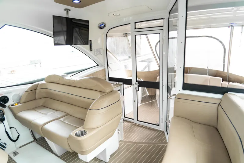 Slide: The Image of 2016 Formula 45 Yacht interior with beige seating, modern design, and glass doors. - 20